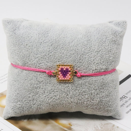 Pulsera hilo y corazón rosa