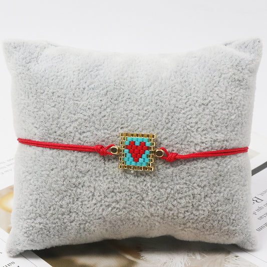 Pulsera hilo corazón rojo